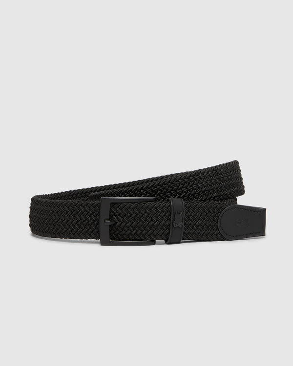 The Psycho Bunny MENS STRETCH BRAIDED BELT (B6A890F200) features a stylish black design with a textured, woven surface. Its matte black metal buckle complements the overall aesthetic perfectly, enhancing comfort and style against a plain background.