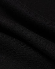 Close-up of the Psycho Bunny MENS MONROE TWILL PATCH SCARF - B6A892D200, showcasing its soft, smooth texture and fine weave. This luxurious black scarf features slight folds and shadows, highlighting its gentle drape and high-quality cotton wool blend.