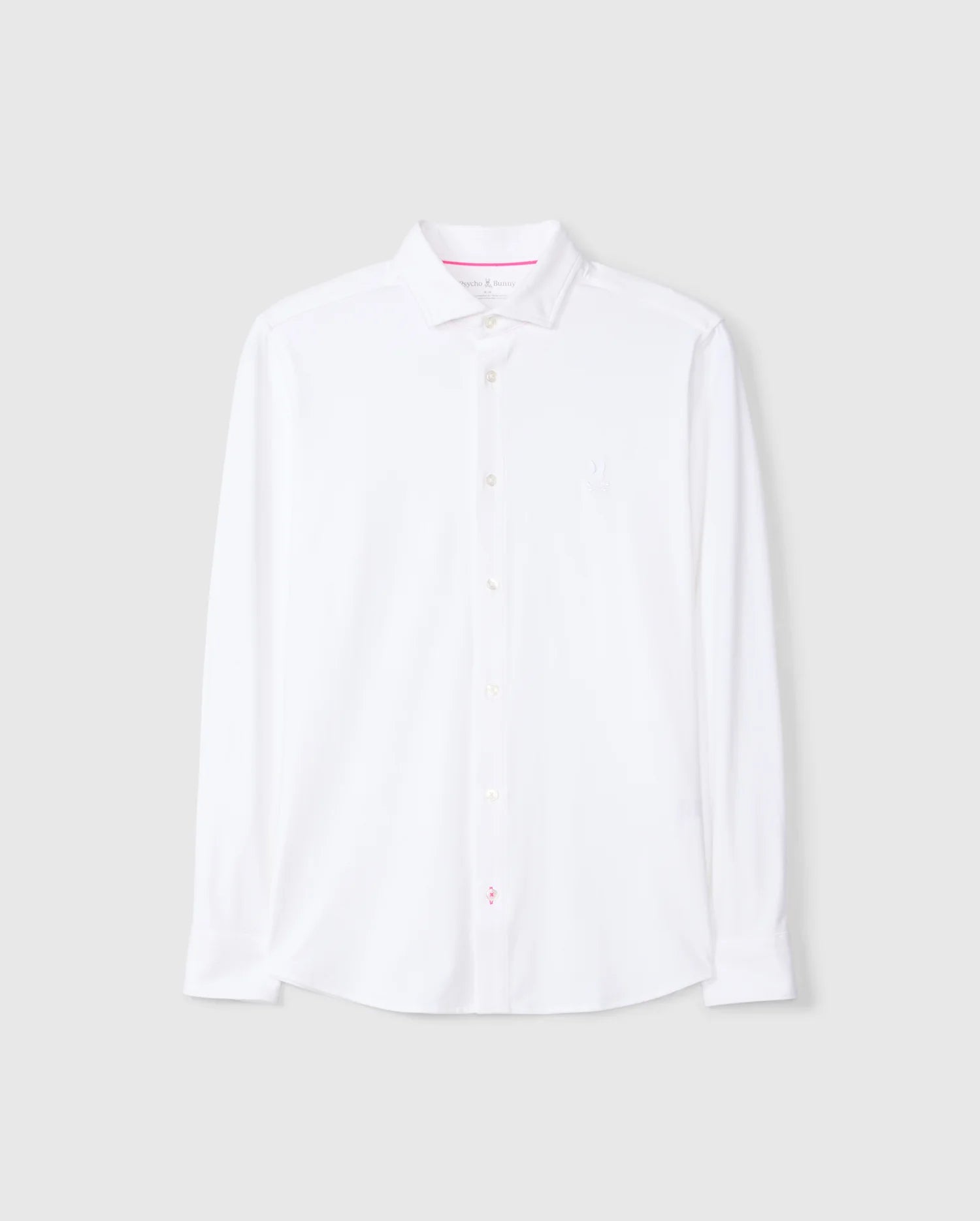 The MENS ARTHUR JERSEY SHIRT - B6C748D200, by Psycho Bunny, is a white long-sleeve button-up dress shirt crafted from premium stretch Pima cotton. Displayed against a light gray background, this shirt features a classic collar and boasts a clean, minimalist design with the brand logo subtly embroidered on the left chest.