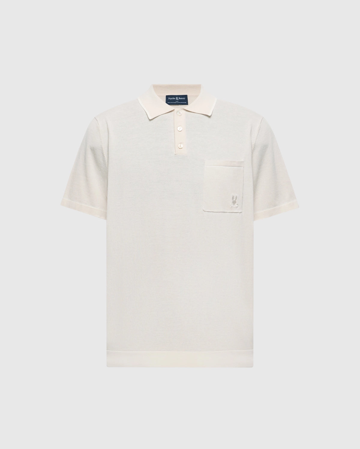 The Psycho Bunny MENS LONGFORD FINE KNIT POLO (B6E500F200) is a cream-colored cotton polo with short sleeves, a collar, three buttons, and an embroidered Bunny on the left chest pocket, shown on a light gray background.