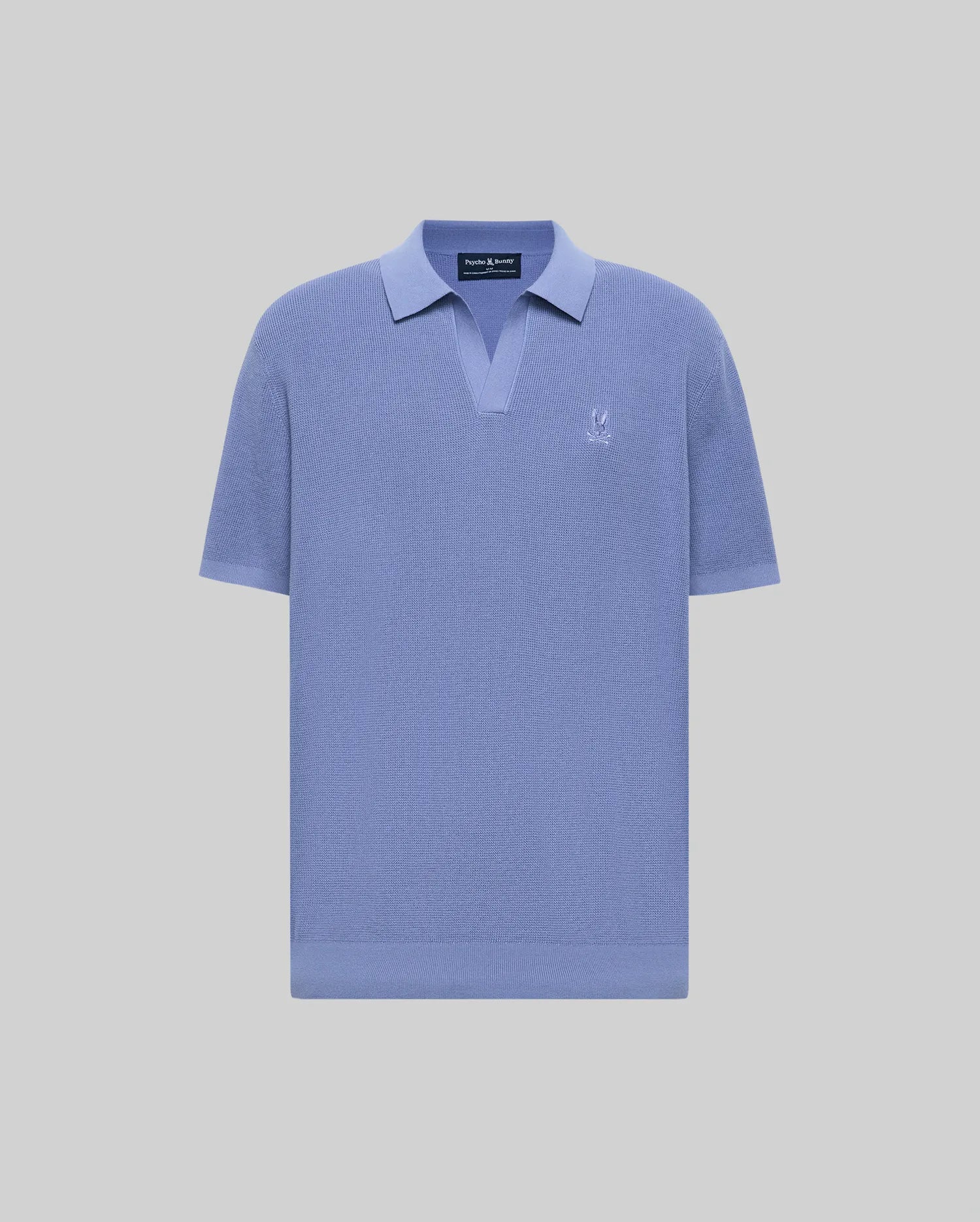 The Psycho Bunny MENS LEETON JOHNNY COLLAR KNIT POLO (B6E562F200) is a short-sleeved, light blue cotton sweater polo with a Johnny collar and small white logo on the left chest, shown on a plain light gray background.