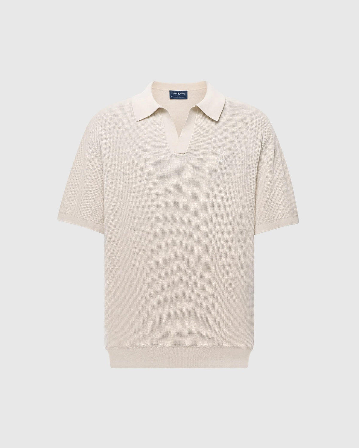 The Psycho Bunny MENS LEETON JOHNNY COLLAR KNIT POLO (B6E562F200) is a beige short-sleeve polo with a subtle V-neck collar, made from soft cotton. It features an embroidered logo on the left chest and offers a slim fit for a casual, classic style ideal for transitional dressing.