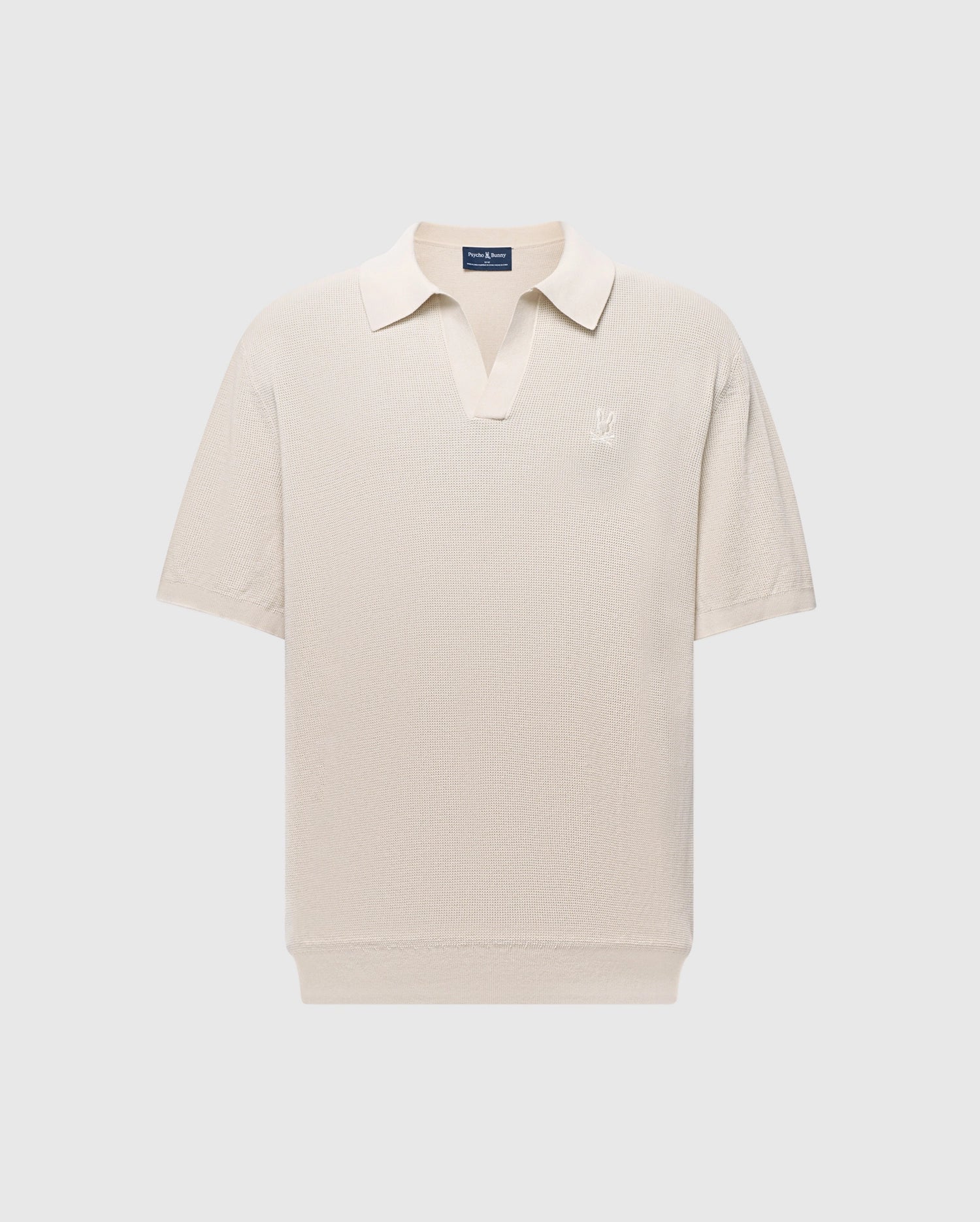 The Psycho Bunny MENS LEETON JOHNNY COLLAR KNIT POLO (B6E562F200) is a beige short-sleeve polo with a subtle V-neck collar, made from soft cotton. It features an embroidered logo on the left chest and offers a slim fit for a casual, classic style ideal for transitional dressing.
