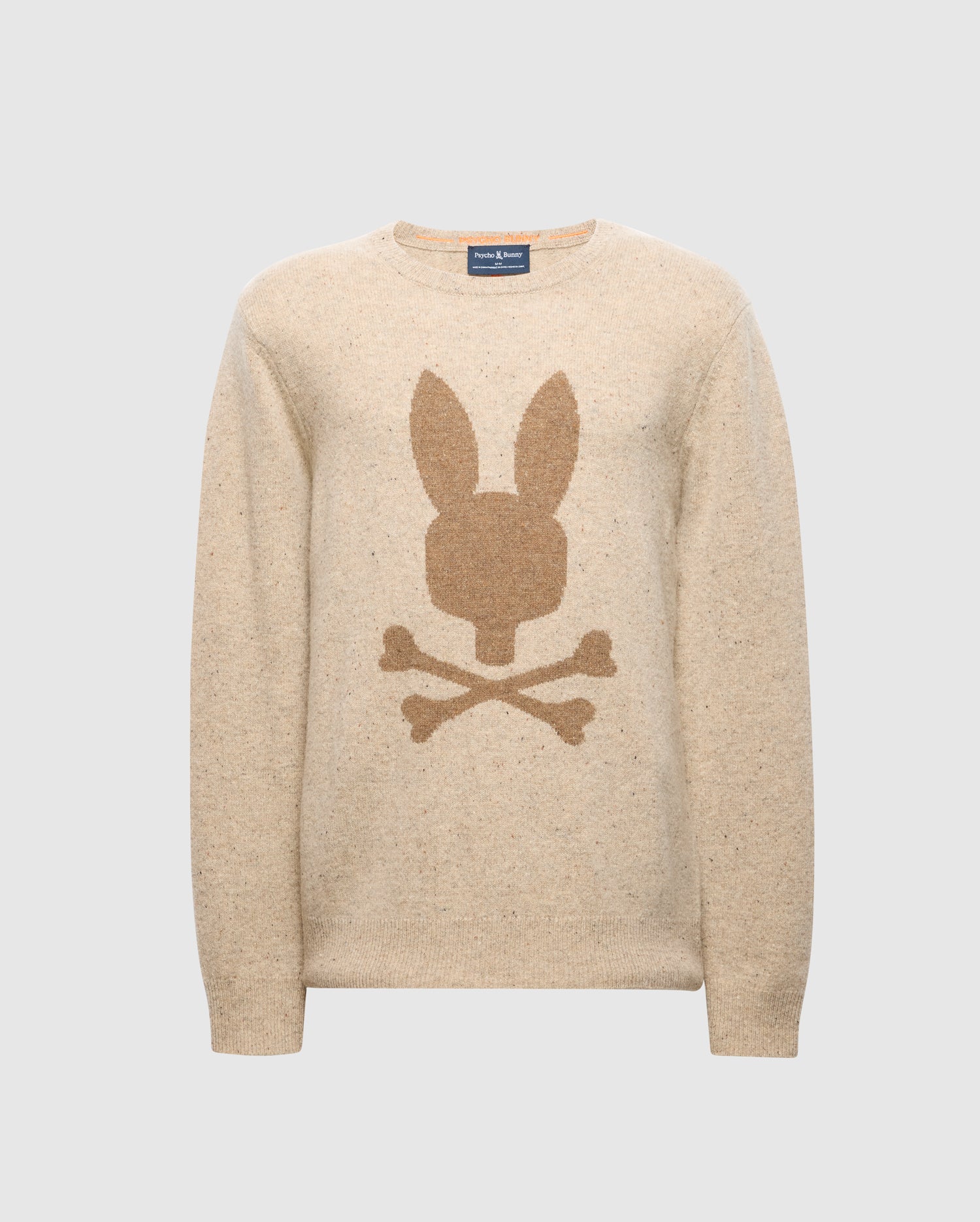 The Men's Lincoln Merino Wool Sweater by Psycho Bunny features a darker beige rabbit head and crossbones design across a plain light gray background. This sweater, ideal for cold weather, seamlessly blends style and comfort in its beige color.