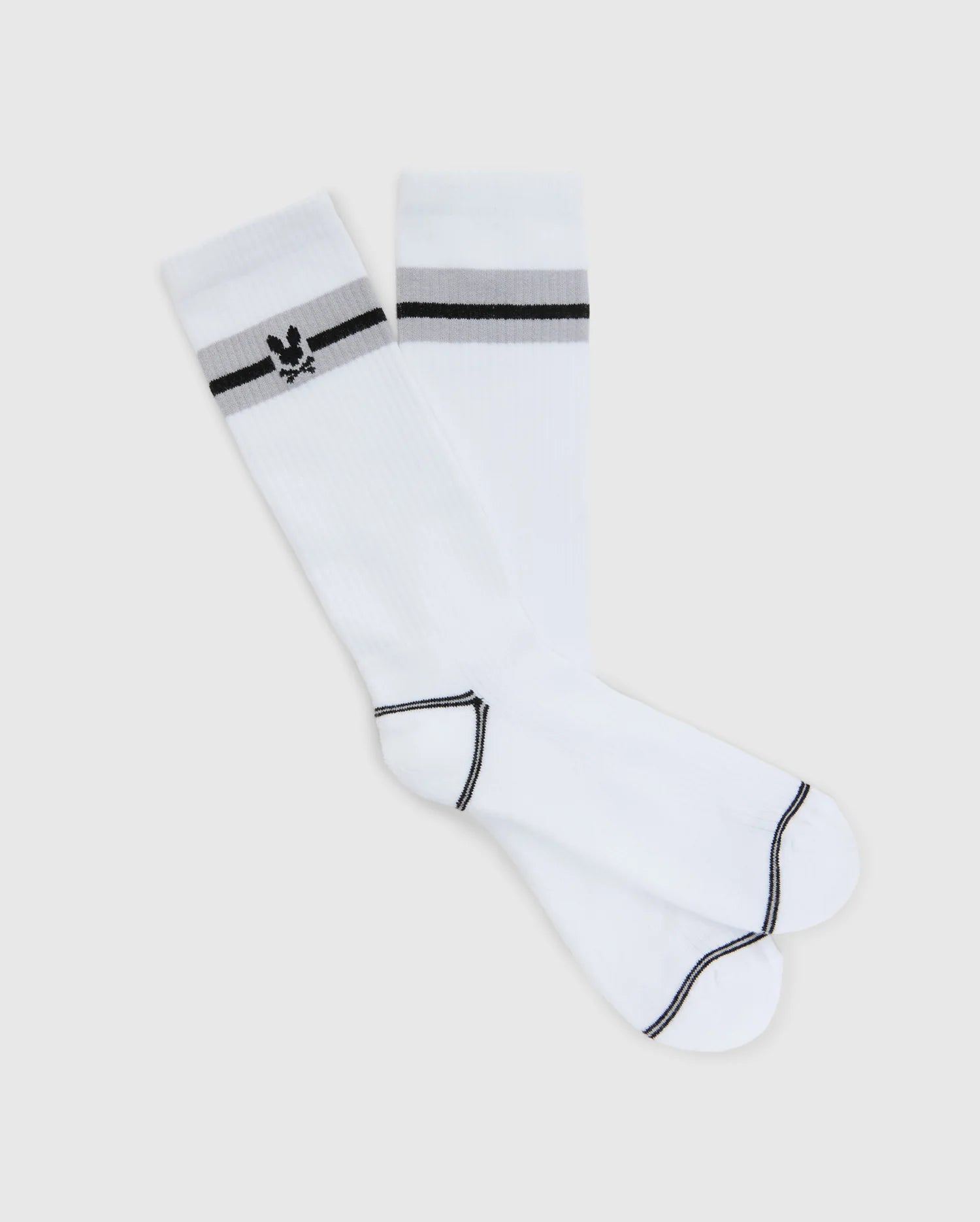 The Psycho Bunny Men's Sport Sock - B6F150E200 features a stylish gray design with black toe and heel trims, classic white accents with black stripes near the top, and an intarsia-knit Bunny logo. Made from soft Peruvian Pima cotton, these socks offer comfort and style.
