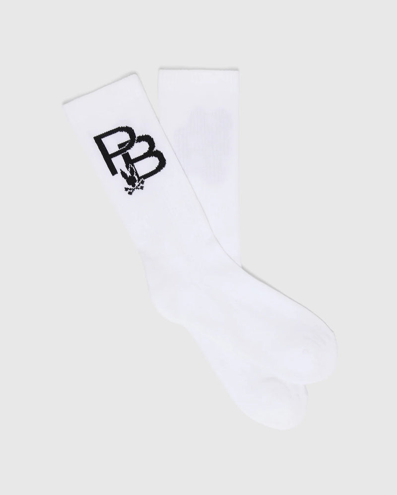 The MENS PB SPORT SOCK - B6F501F200 by Psycho Bunny features a sporty flex design with a black "PB" and rabbit graphic on white. Made from soft Pima cotton, these socks deliver comfort against a light gray background.