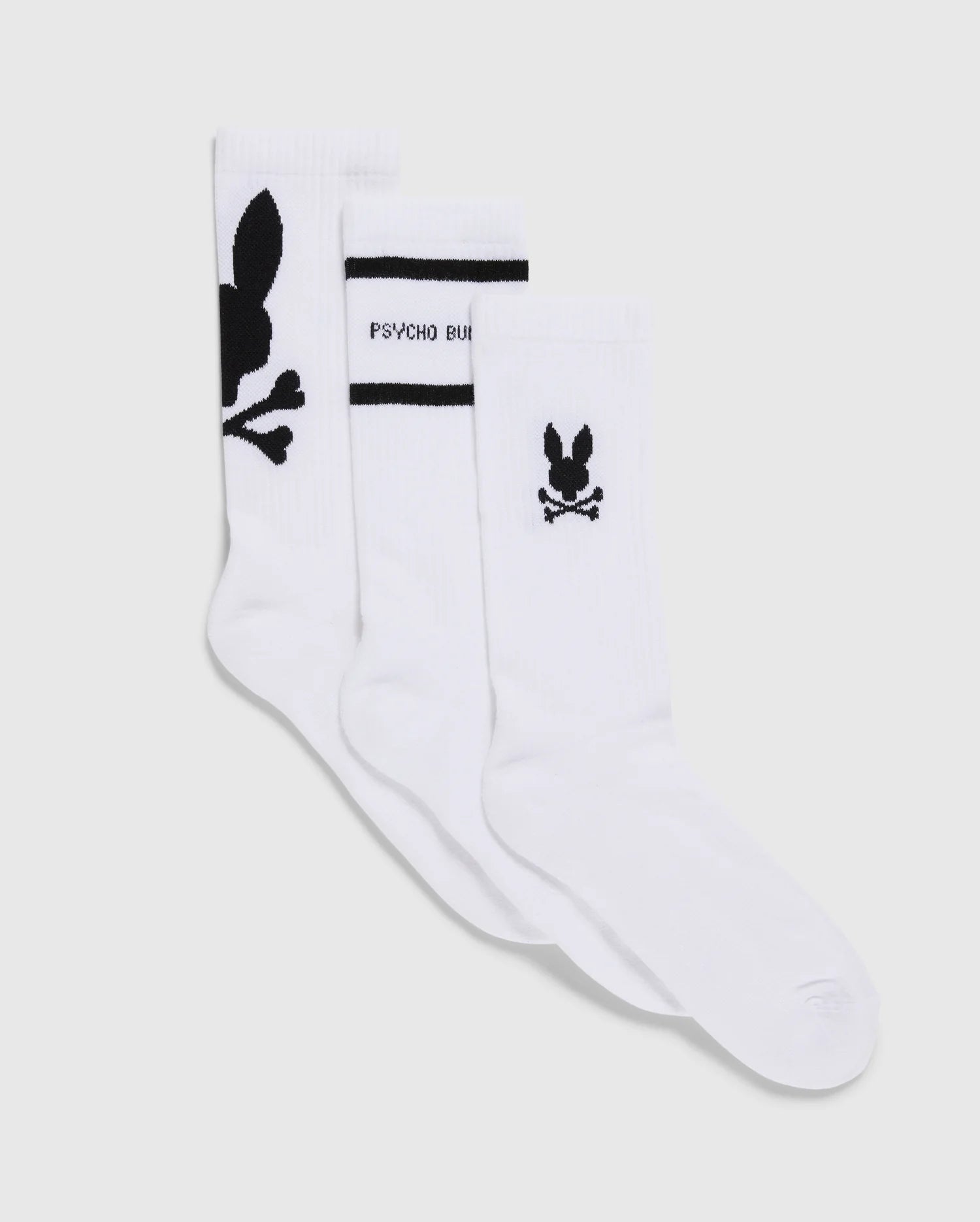 The MENS 3 PACK SPORT SOCK - B6F997D200 by Psycho Bunny showcases three pairs of luxurious Peruvian Pima cotton sport socks. One pair is adorned with a prominent black bunny logo and crossbones, the second features a smaller logo above the heel accompanied by 