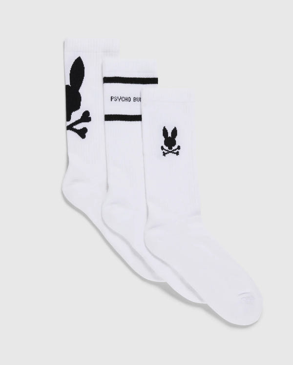 The MENS 3 PACK SPORT SOCK - B6F997D200 by Psycho Bunny showcases three pairs of luxurious Peruvian Pima cotton sport socks. One pair is adorned with a prominent black bunny logo and crossbones, the second features a smaller logo above the heel accompanied by "Psycho Bunny" text, and the third sports a small bunny logo with crossbones near the ankle. This versatile 3-pack is perfect for any occasion.