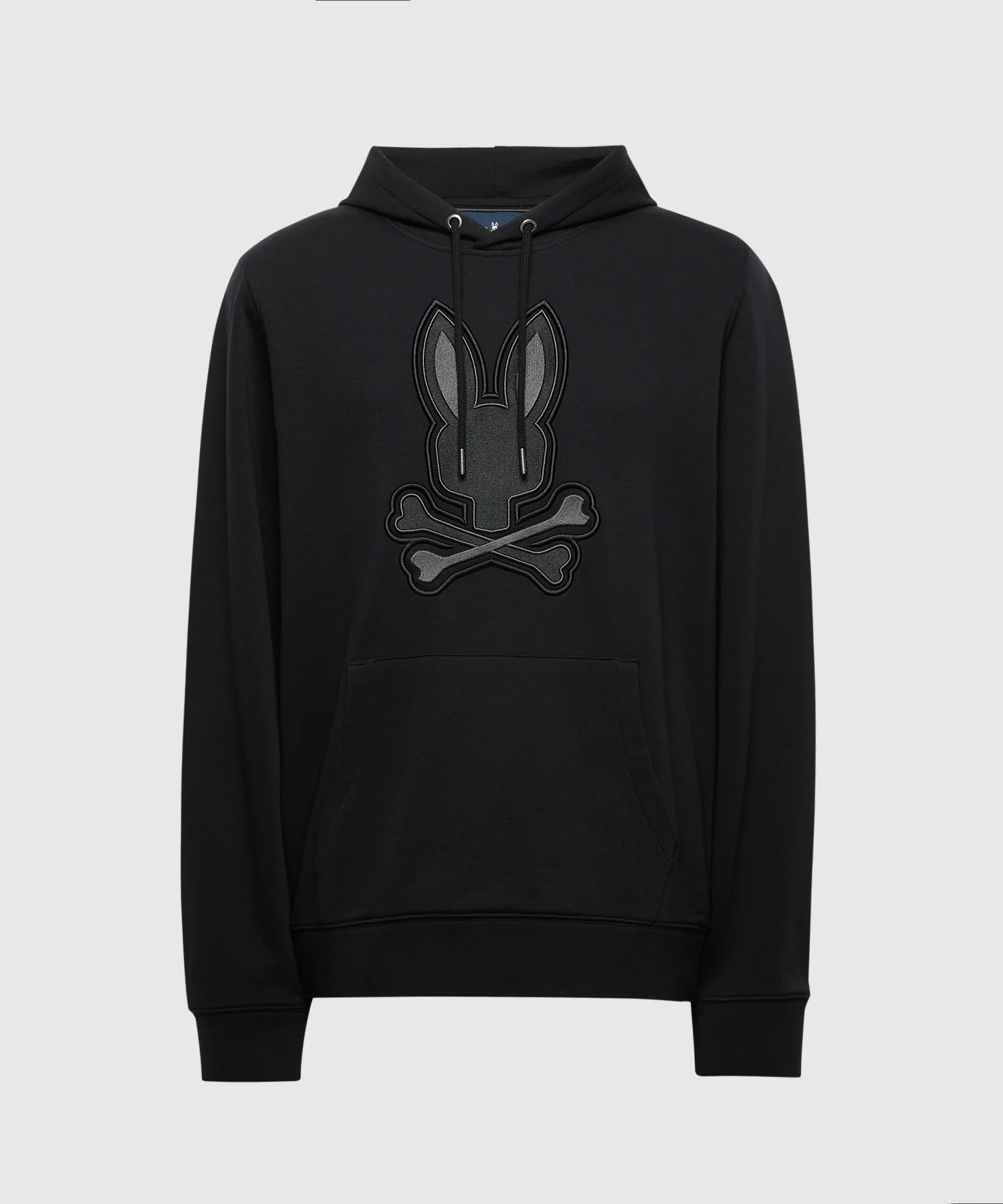 The MENS NEW CASTLE EMBROIDERED FRENCH TERRY HOODIE by Psycho Bunny, B6H517F200, is a black hoodie with a large embroidered stylized bunny above crossed bones. It features a drawstring hood, front pocket, and relaxed fit for ultimate comfort.