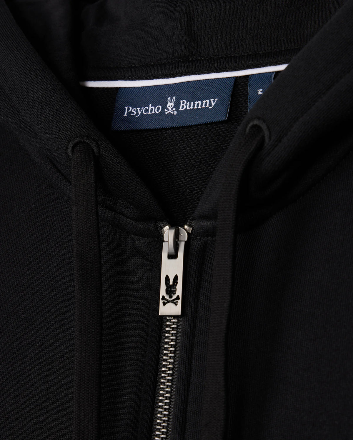 Close-up of the MENS LEVY ZIP FLEECE HOODIE - B6H720D200, focusing on a black cotton hoodie for men with a zipper featuring the iconic bunny logo and a "Psycho Bunny" label.
