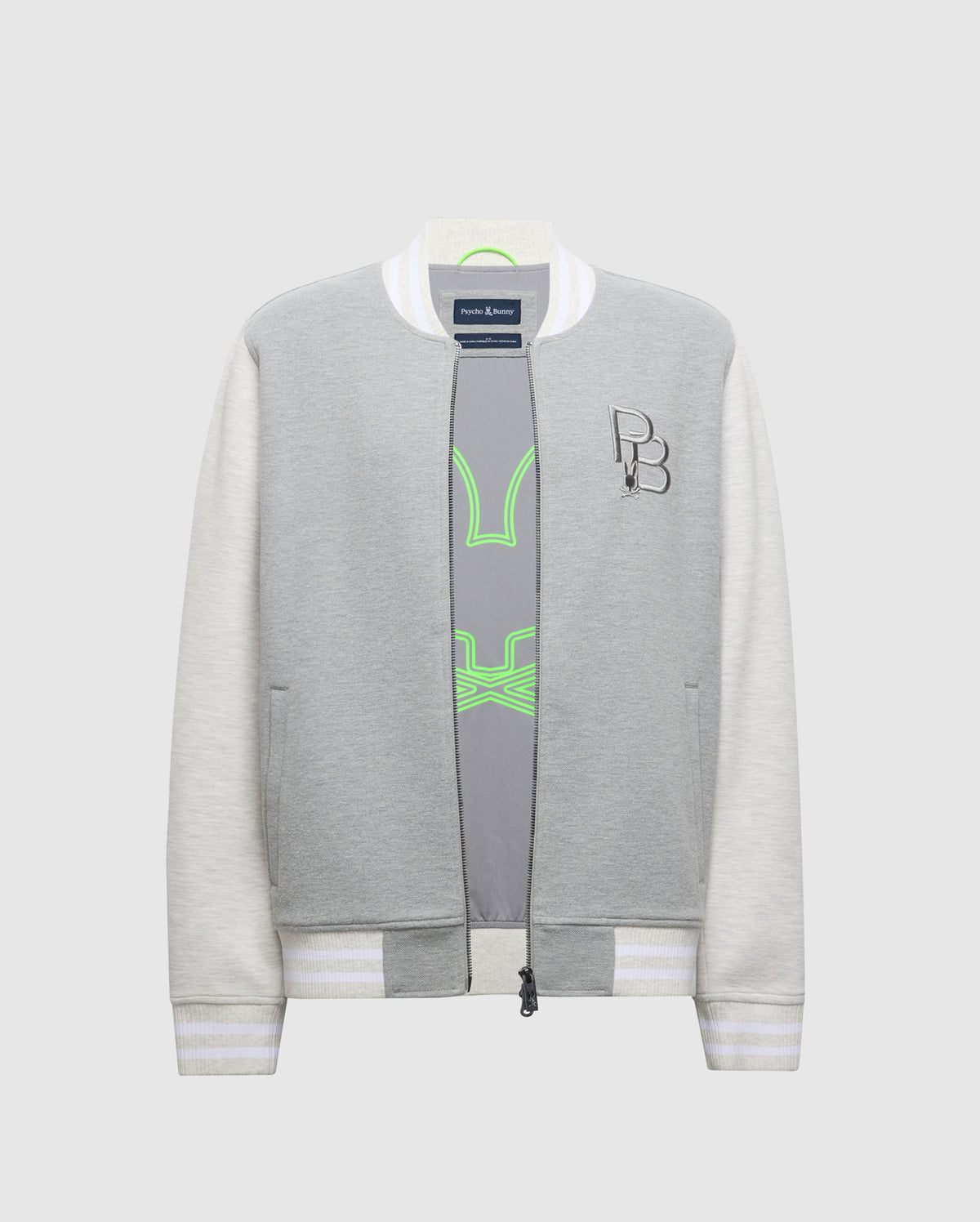 The Psycho Bunny MENS HYDRA COLOR BLOCK KNIT BOMBER (B6J455F200) is a gray and white bomber jacket crafted from a premium cotton blend. It features striped ribbed cuffs, collar, an embroidered Bunny logo on the chest, and reveals a gray top with neon green accents when unzipped.