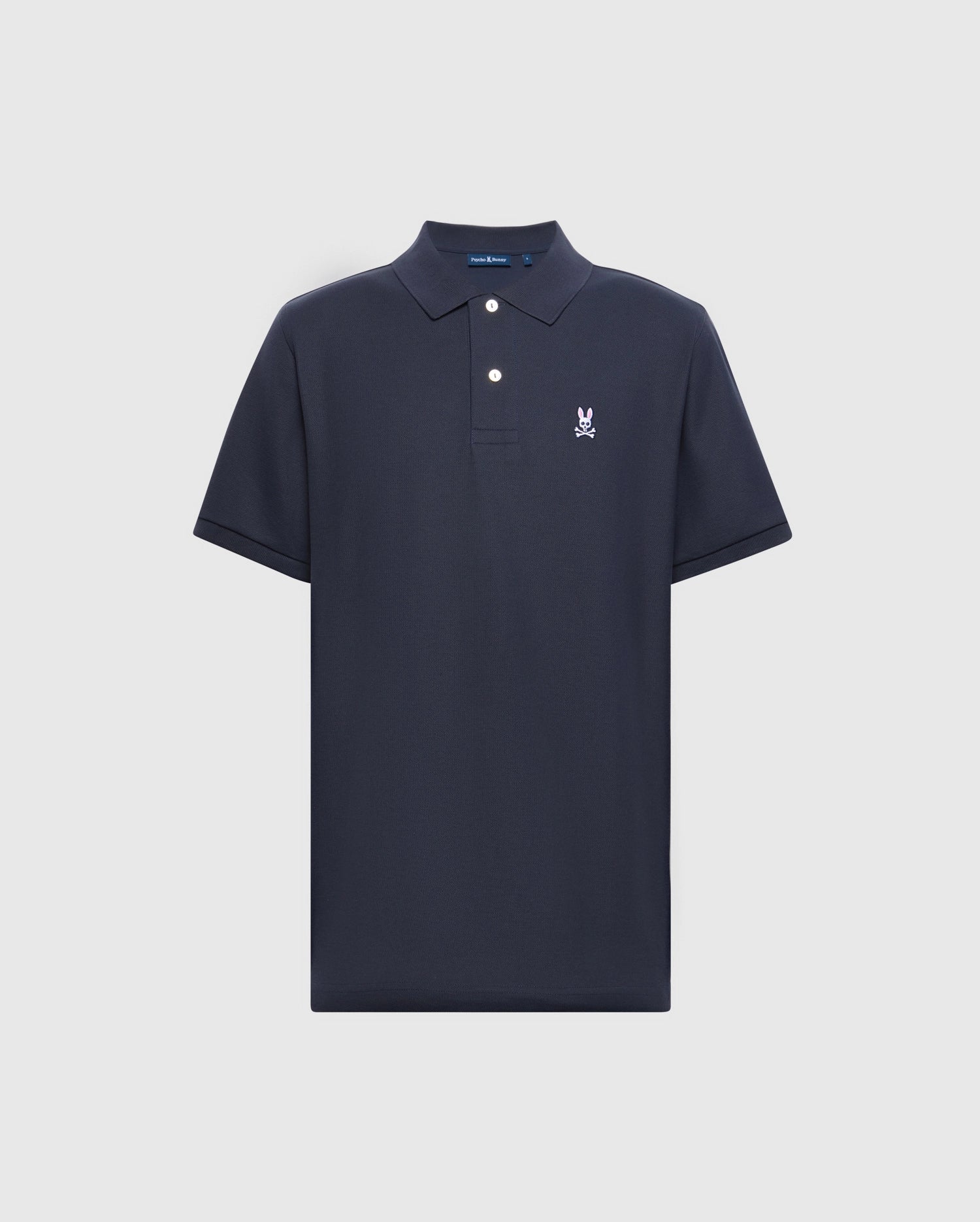 Psycho Bunny's MENS CLASSIC PIQUE POLO SHIRT - B6K001ARPC is a navy blue polo featuring short sleeves, a timeless collar, and an embroidered white logo on the left chest. Crafted from 100% Pima cotton, it includes a buttoned placket with mother-of-pearl buttons against a plain light background.