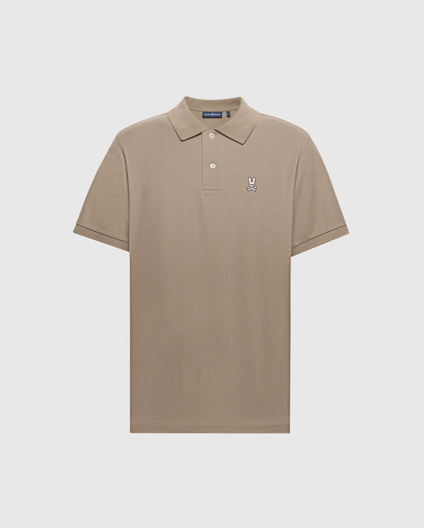 The Psycho Bunny MENS CLASSIC PIQUE POLO SHIRT (B6K001CRPC) is a beige, soft Pima cotton polo with short sleeves, a two-button collar, and the signature logo embroidered on the left chest.