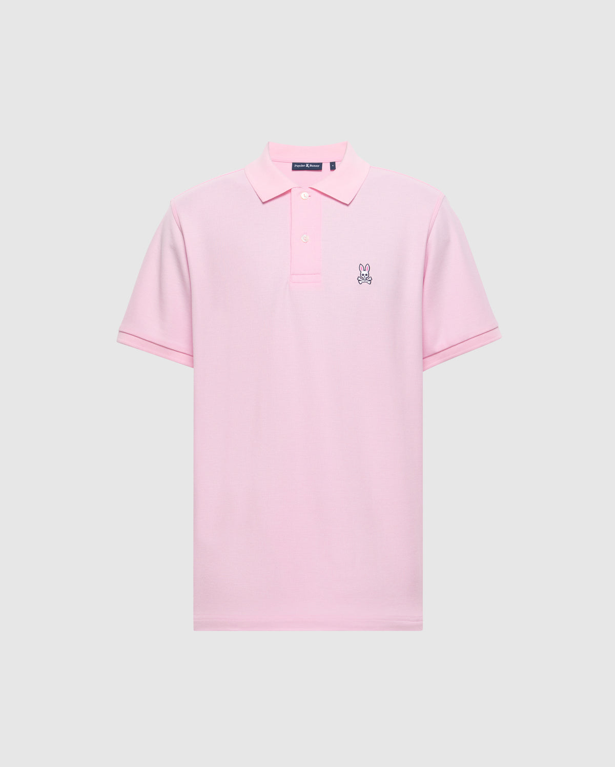 The Psycho Bunny Men's Classic Pique Polo Shirt (B6K001CRPC) is crafted from soft Peruvian pima cotton in light pink, with a collar, three buttons, and a small embroidered bunny logo on the left chest against a plain gray background.