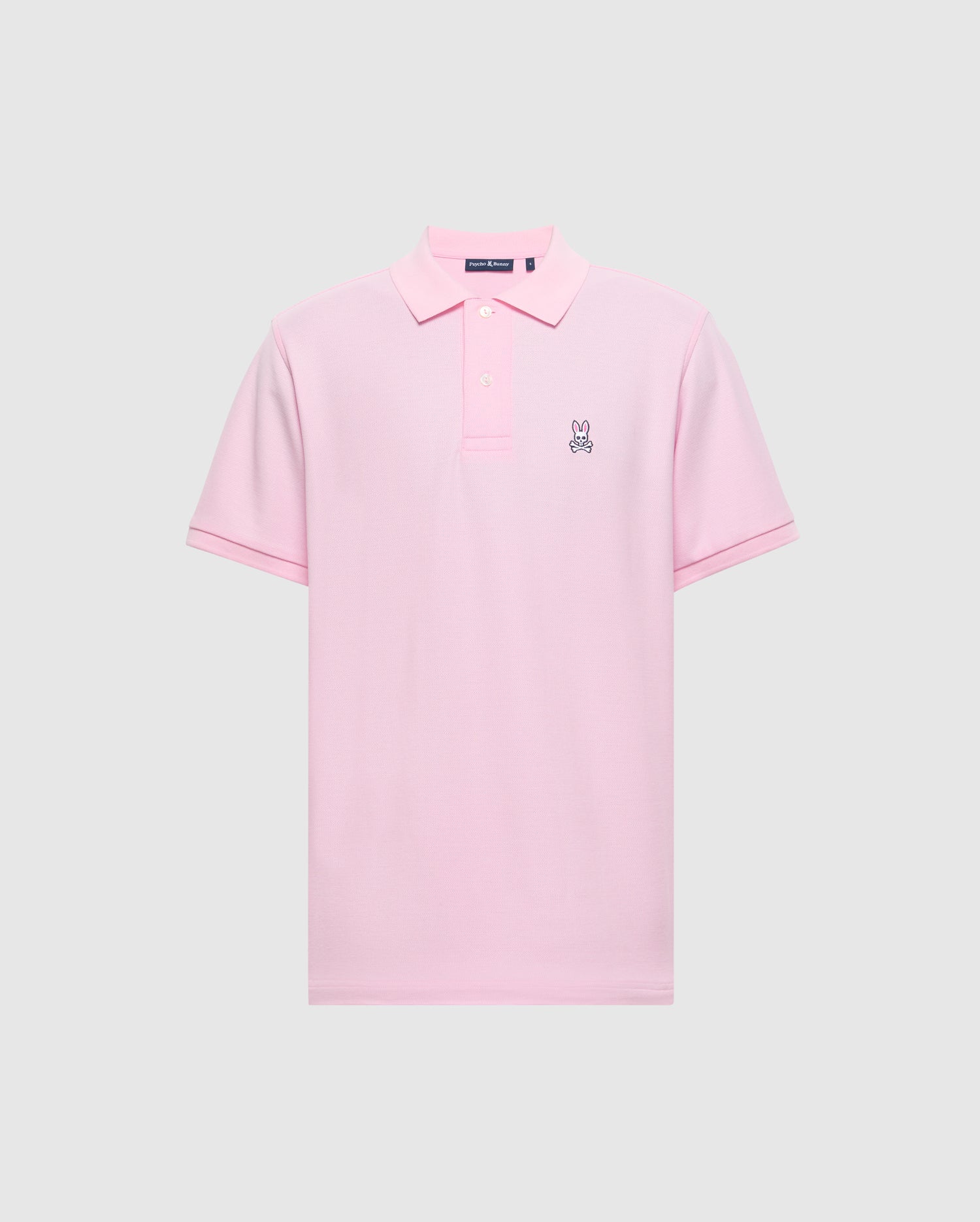 The Psycho Bunny Men's Classic Pique Polo Shirt (B6K001CRPC) is crafted from soft Peruvian pima cotton in light pink, with a collar, three buttons, and a small embroidered bunny logo on the left chest against a plain gray background.