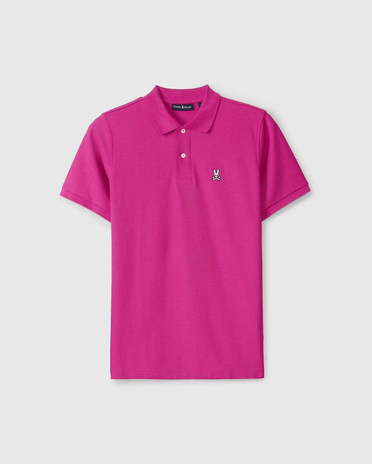 The Psycho Bunny Men's Classic Pique Polo Shirt (B6K001D200) is a bright pink, 100% Pima cotton shirt made in Peru. It features a collar, short sleeves, and an embroidered bunny logo on the left chest. Displayed against a plain white background.