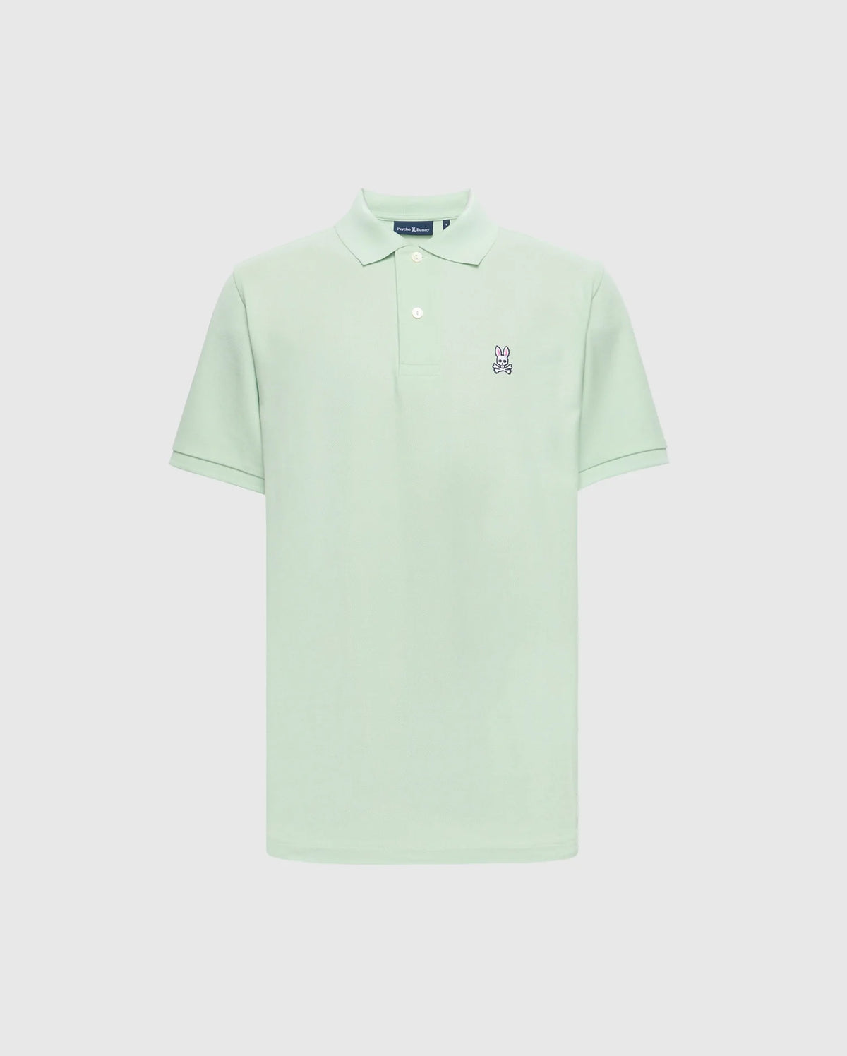 The Psycho Bunny Men's Classic Pique Polo (B6K001F200) in light green Pima cotton features a collar, short sleeves, and an embroidered Bunny logo with crossbones on the left chest against a plain white backdrop.