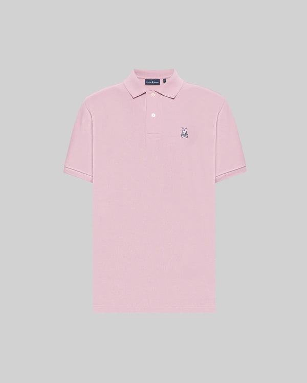The Psycho Bunny MENS CLASSIC PIQUE POLO SHIRT - B6K001F200 is a light pink men’s short-sleeve polo made from soft Pima cotton, featuring a collar, two buttons, and an embroidered Bunny logo on the left chest. Solid light gray background.