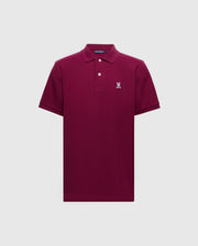 The Psycho Bunny Men's Classic Pique Polo Shirt - B6K001Z1PC features a maroon color crafted from soft Pima cotton, short sleeves, collar with two buttons, and a distinguished embroidered Bunny logo on the left chest on a plain light gray background.