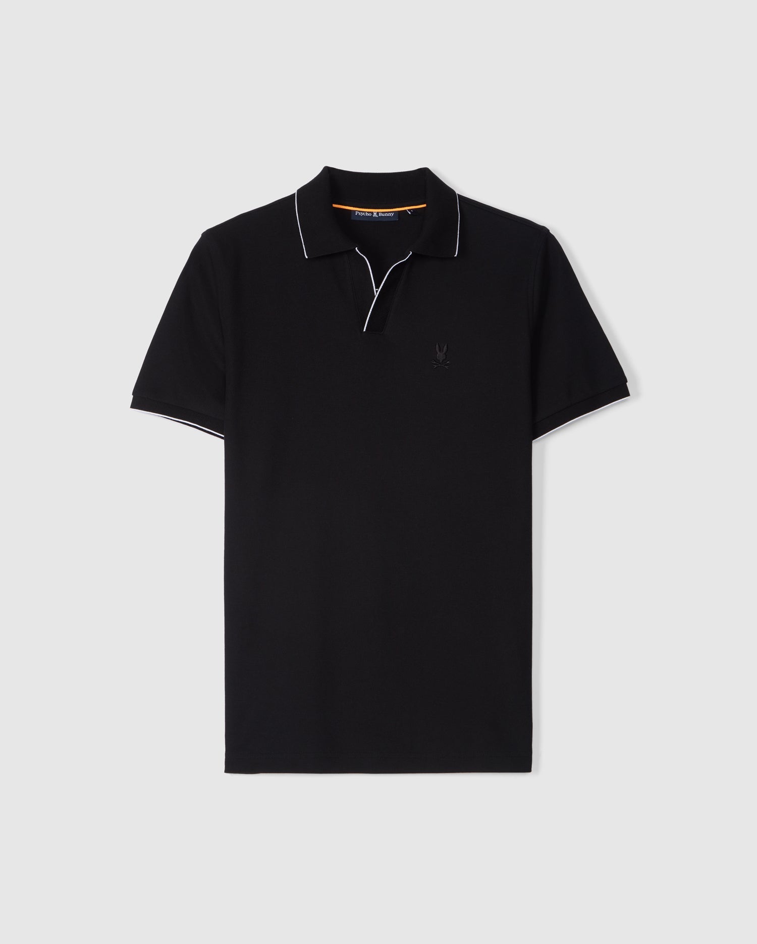 The MENS EAST HILLS JOHNNY COLLAR POLO SHIRT - B6K331B200 by Psycho Bunny is a black short-sleeved shirt with a Johnny collar and white piping along the edges. Made from luxurious Pima cotton, it features a small embroidered logo on the left chest area. The background is plain white.