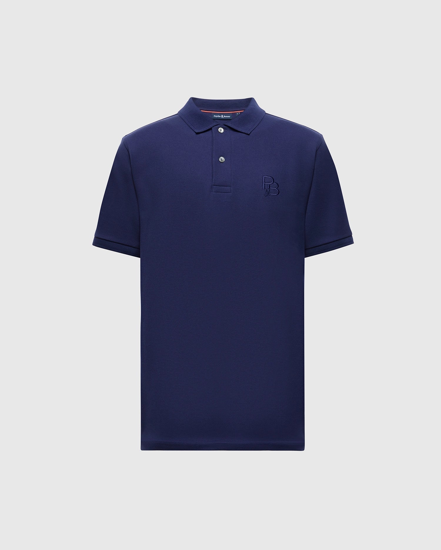 The Psycho Bunny MENS NICHOLSON RIB COLLAR PIQUE POLO - B6K401F200 is a navy blue shirt made from Pima cotton, featuring a classic collar, short sleeves, two buttons, and a subtle embroidered logo on the chest against a light gray background.