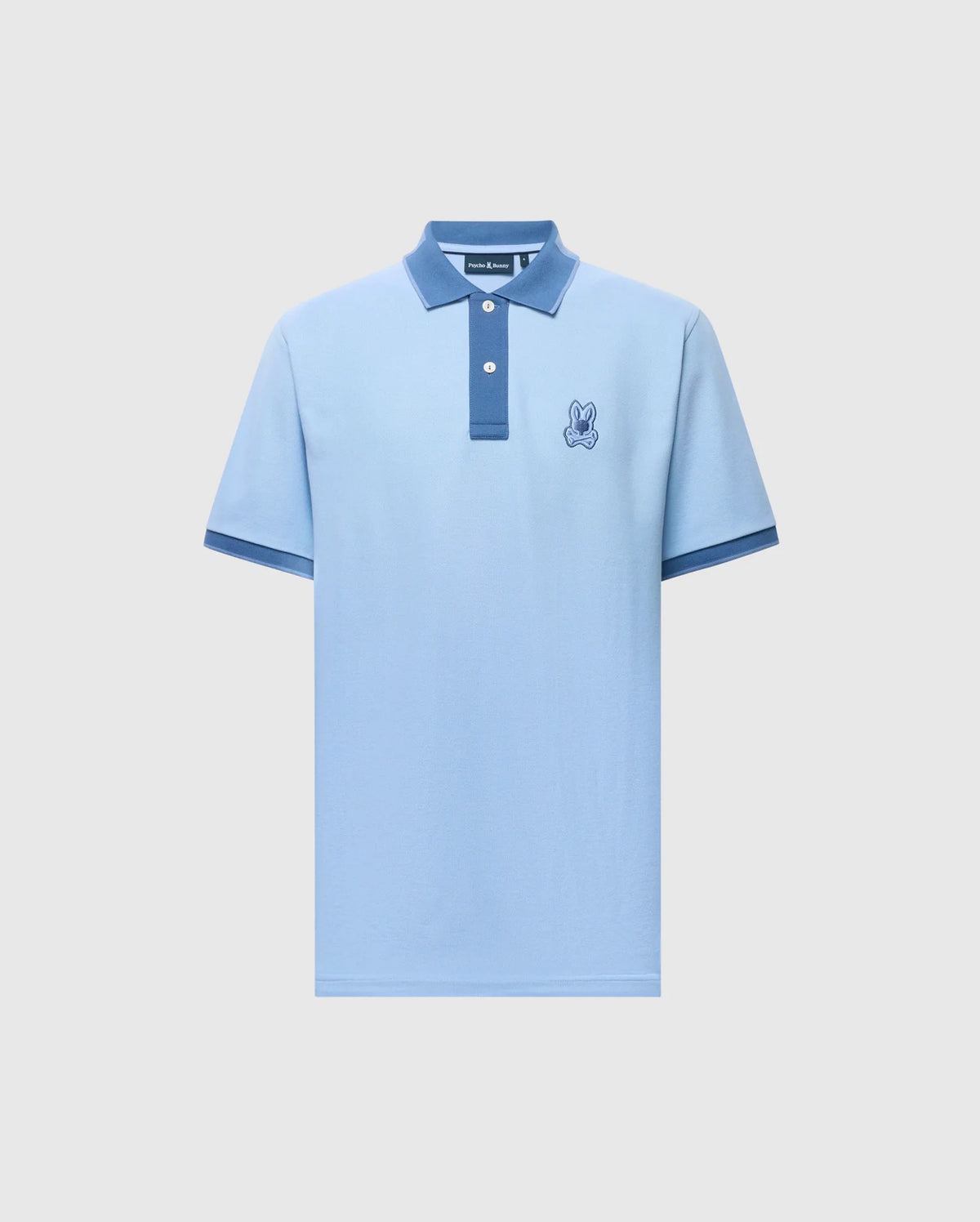The MENS NEW CASTLE PIQUE POLO - B6K487F200 by Psycho Bunny is a light blue slim-fit polo made of premium Pima Cotton. It features a textured darker blue collar and cuffs, a two-button placket, and an embroidered rabbit emblem on the left chest against a plain white background.