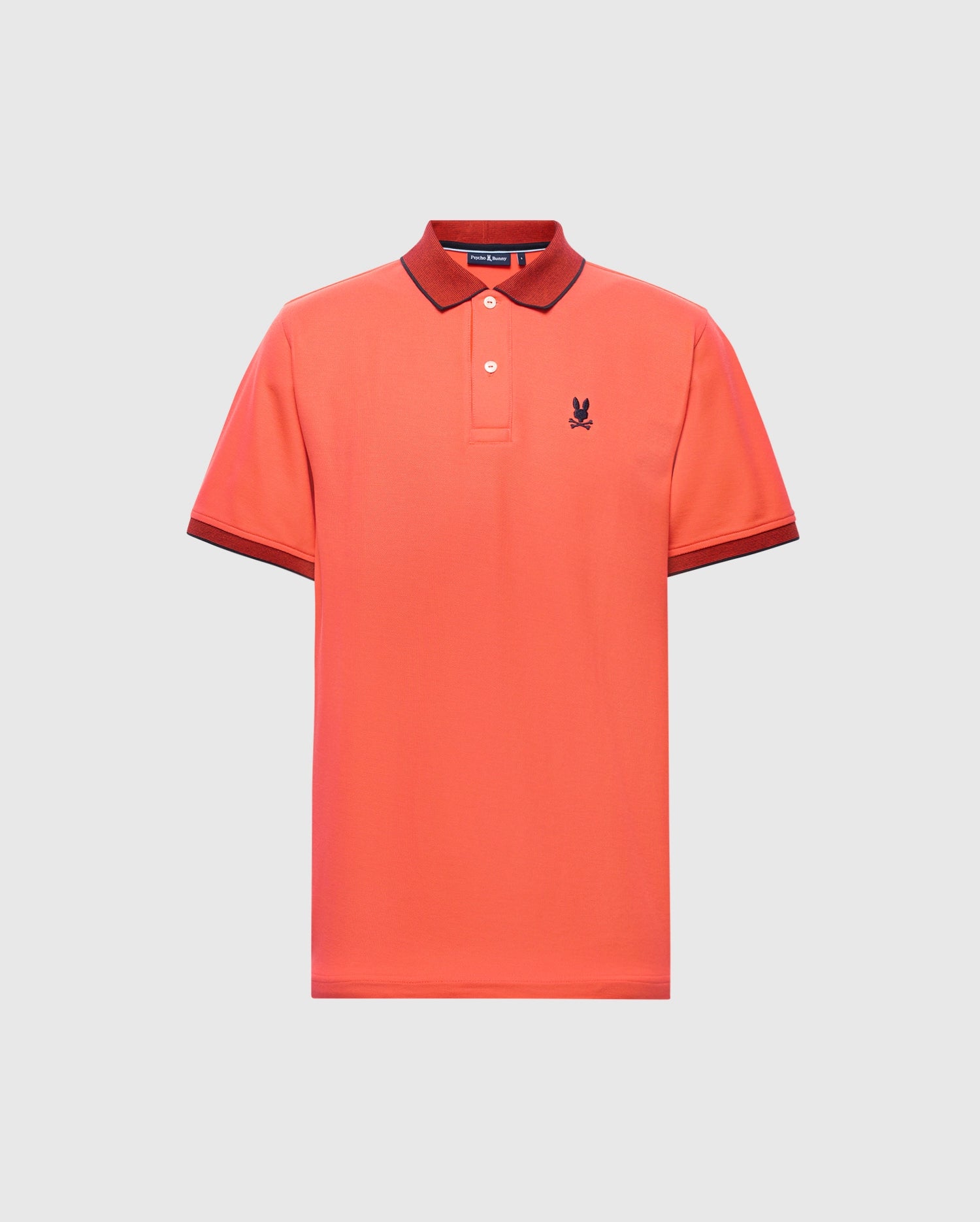 The Psycho Bunny MENS JONAS MICRO STRIPE COLLAR PIQUE POLO (B6K583F200) is coral with a micro-stripe pattern, regular fit, dark red collar and cuffs, made from soft Pima cotton with an embroidered standing rabbit logo on the left chest. It's displayed on a plain light gray background.