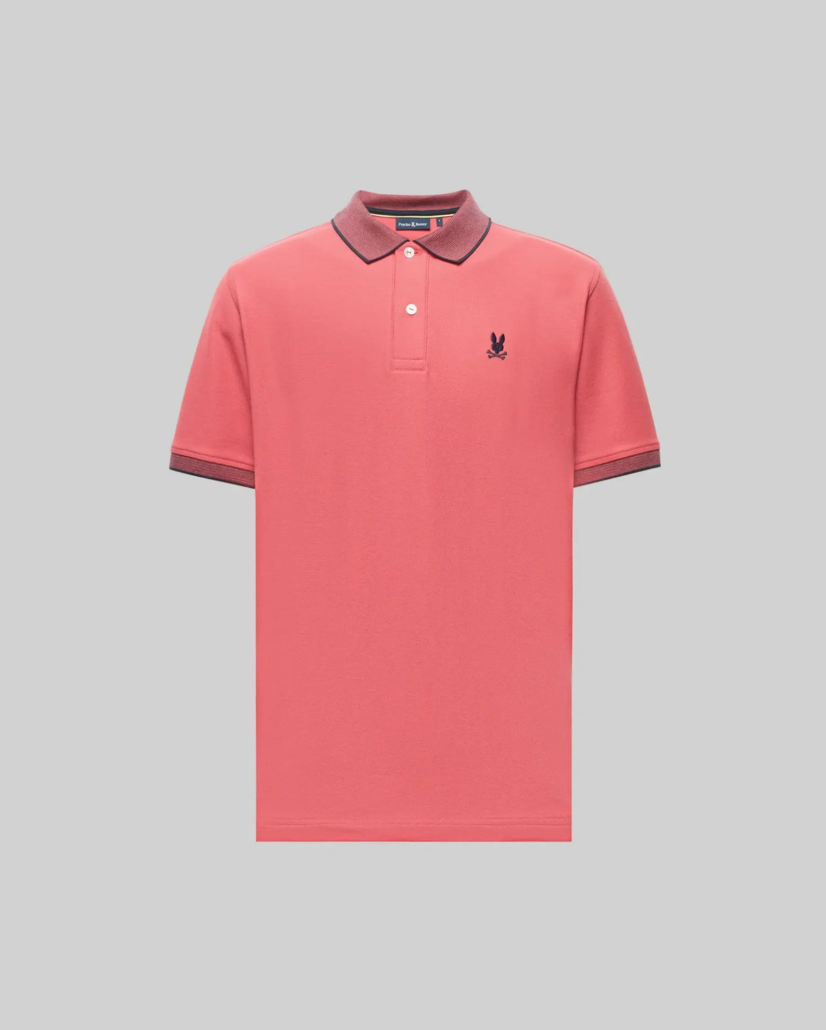 The Psycho Bunny MENS JONAS MICRO STRIPE COLLAR PIQUE POLO (B6K583F200) in coral pink is crafted from soft Pima cotton, features a dark micro-stripe collar and cuffs, buttoned neckline, and a small embroidered logo on the left chest.