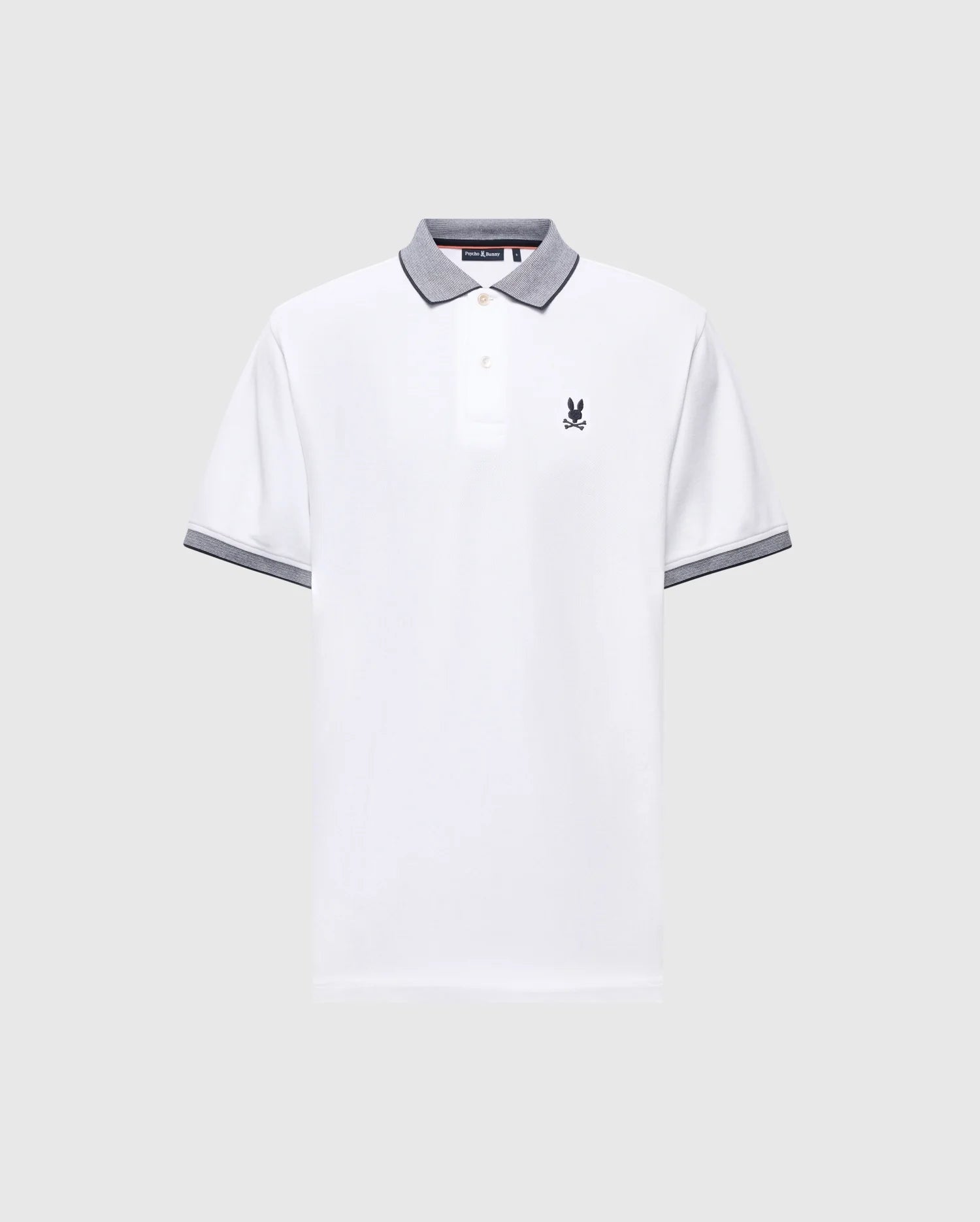 The Psycho Bunny MENS JONAS STRIPE COLLAR PIQUE POLO (B6K583F200) features white Pima cotton, gray striped trim on the collar and cuffs, a buttoned placket, and a small embroidered logo on the left chest. Displayed on light gray background.