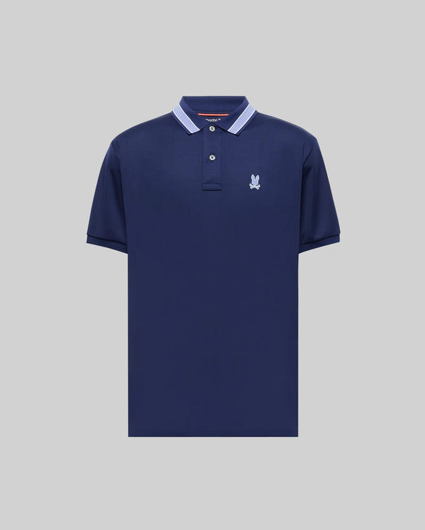 The Psycho Bunny MENS FORREST SPORT PIQUE POLO (B6K660F200) is a navy slim-fit polo with white collar trim and a light embroidered logo on the left chest, made from moisture-wicking fabric and shown on a plain gray background.