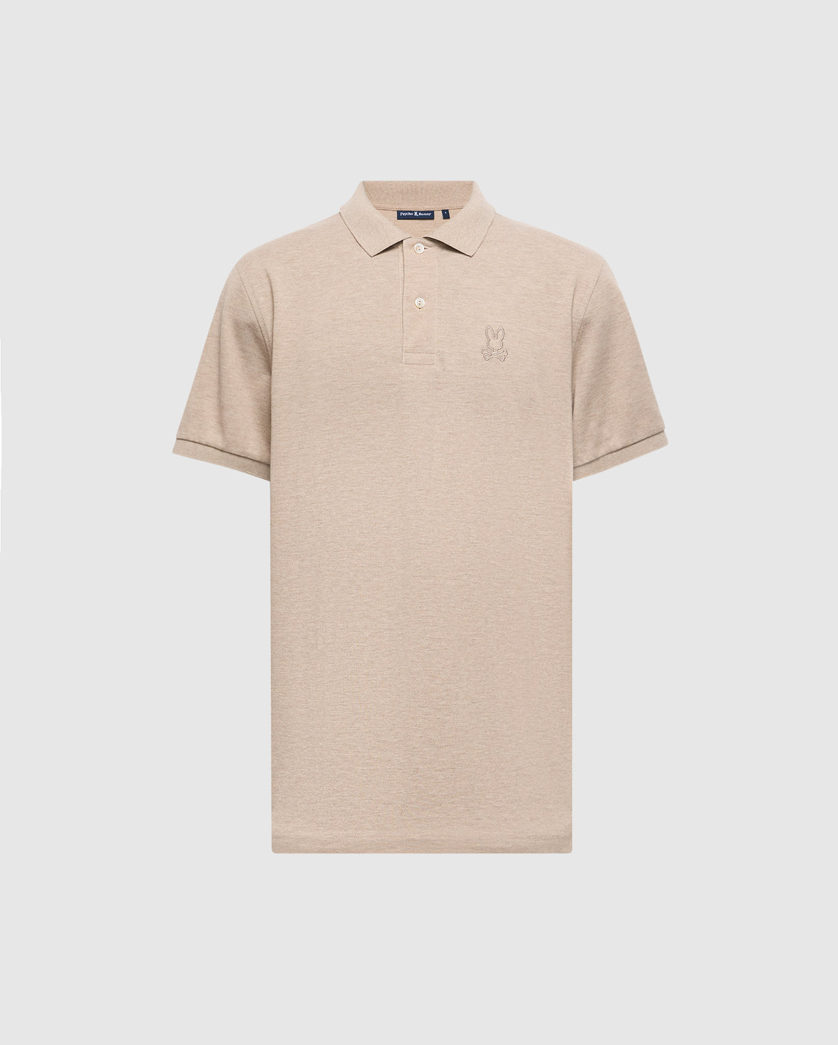 The MENS JAMES PREMIUM PIQUE POLO SHIRT - B6K945D200 by Psycho Bunny is a beige polo shirt, expertly crafted from durable Pima cotton. It features a subtle embroidered logo on the chest and is designed with short sleeves and a collar, offering a lightweight construction for a classic look set against a plain light gray background.