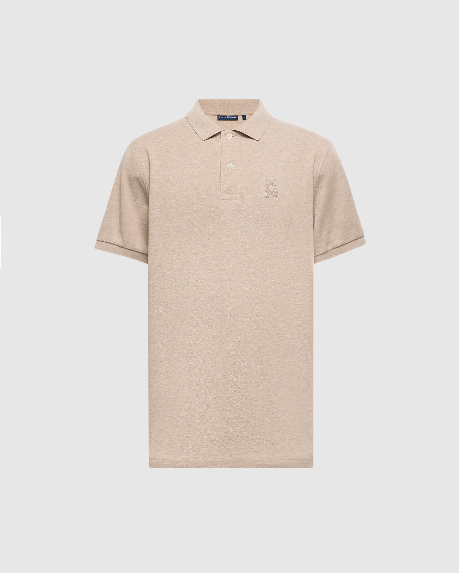 The MENS JAMES PREMIUM PIQUE POLO SHIRT - B6K945D200 by Psycho Bunny is a beige polo shirt, expertly crafted from durable Pima cotton. It features a subtle embroidered logo on the chest and is designed with short sleeves and a collar, offering a lightweight construction for a classic look set against a plain light gray background.
