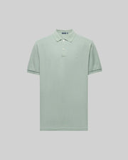 The Psycho Bunny MENS JAMES PREMIUM PIQUE POLO (B6K945D200) is a light green, short-sleeve shirt in soft Pima cotton with a crease-resistant collar, two-button placket, and subtle left chest logo, shown against a light grey background.