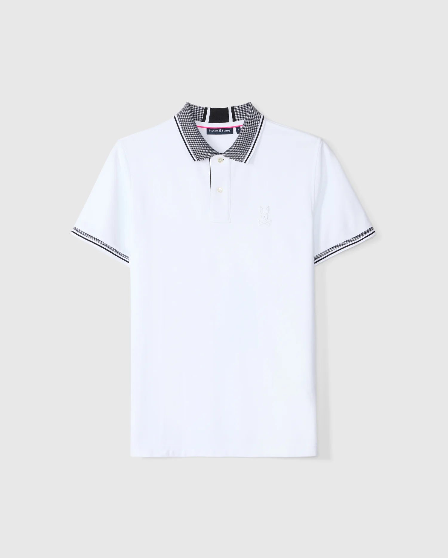 A white Pima cotton polo shirt with a gray collar and diamond knit trim on the sleeves, featuring a subtle embroidered Psycho Bunny logo on the chest and a buttoned placket. The background is plain gray. This product is known as the Psycho Bunny Men's Malton Pique Polo Shirt - B6K950D200.