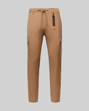 The Psycho Bunny MENS LLOYD CARGO JOGGER - B6P159B200 features tan fabric, elastic waistband, drawstring, side pockets, and a black-and-orange tag on a belt loop—perfect for upgrading your men's pants collection. Shown on a plain light gray background.
