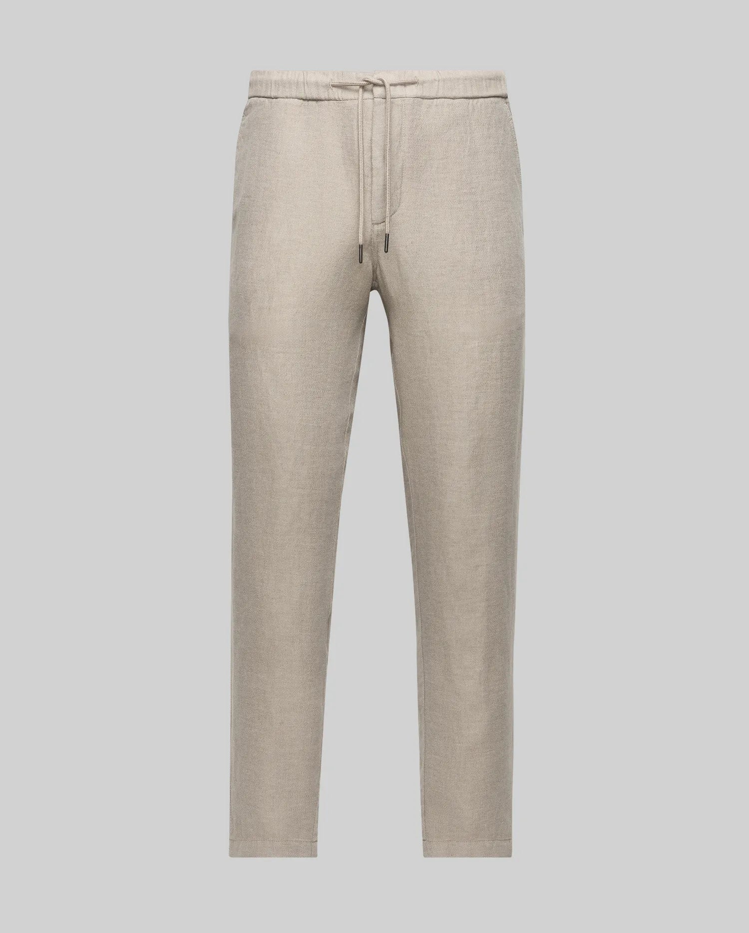 The Psycho Bunny MENS FATE LINEN DRAWSTRING PANT (B6P471C200) features light beige linen-blend fabric, a drawstring waist, and straight legs for cool comfort, shown against a plain light gray background.