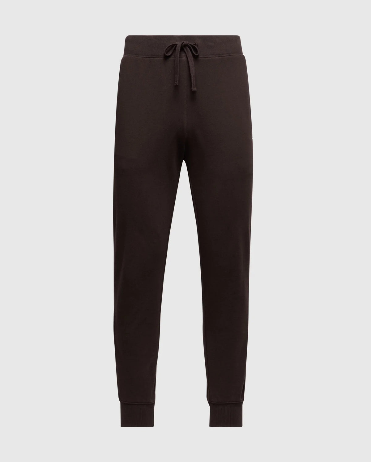 Introducing the Psycho Bunny Men's Levy Essential Fleece Sweatpant - B6P721D200, a stylish pair of black jogger pants equipped with an elastic waistband and drawstring. Crafted from 100% cotton for ultimate comfort, these casualwear essentials feature ribbed cuffs at the ankles and are showcased against a plain, light grey background.