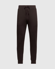 Introducing the Psycho Bunny Men's Levy Essential Fleece Sweatpant - B6P721D200, a stylish pair of black jogger pants equipped with an elastic waistband and drawstring. Crafted from 100% cotton for ultimate comfort, these casualwear essentials feature ribbed cuffs at the ankles and are showcased against a plain, light grey background.