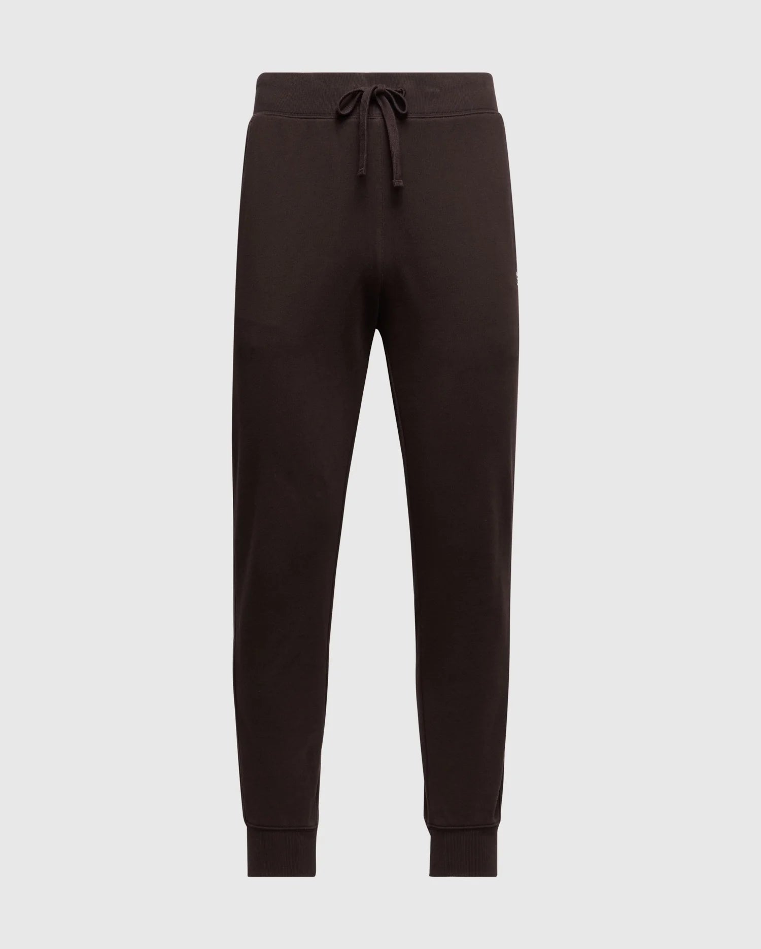 Introducing the Psycho Bunny Men's Levy Essential Fleece Sweatpant - B6P721D200, a stylish pair of black jogger pants equipped with an elastic waistband and drawstring. Crafted from 100% cotton for ultimate comfort, these casualwear essentials feature ribbed cuffs at the ankles and are showcased against a plain, light grey background.