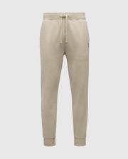 The MENS LEVY ESSENTIAL FLEECE SWEATPANTS - B6P721D200 by Psycho Bunny are beige sweatpants made from ultra-soft cotton fleece, featuring an elastic waistband with a drawstring, side pockets, and ribbed ankle cuffs against a plain white background.
