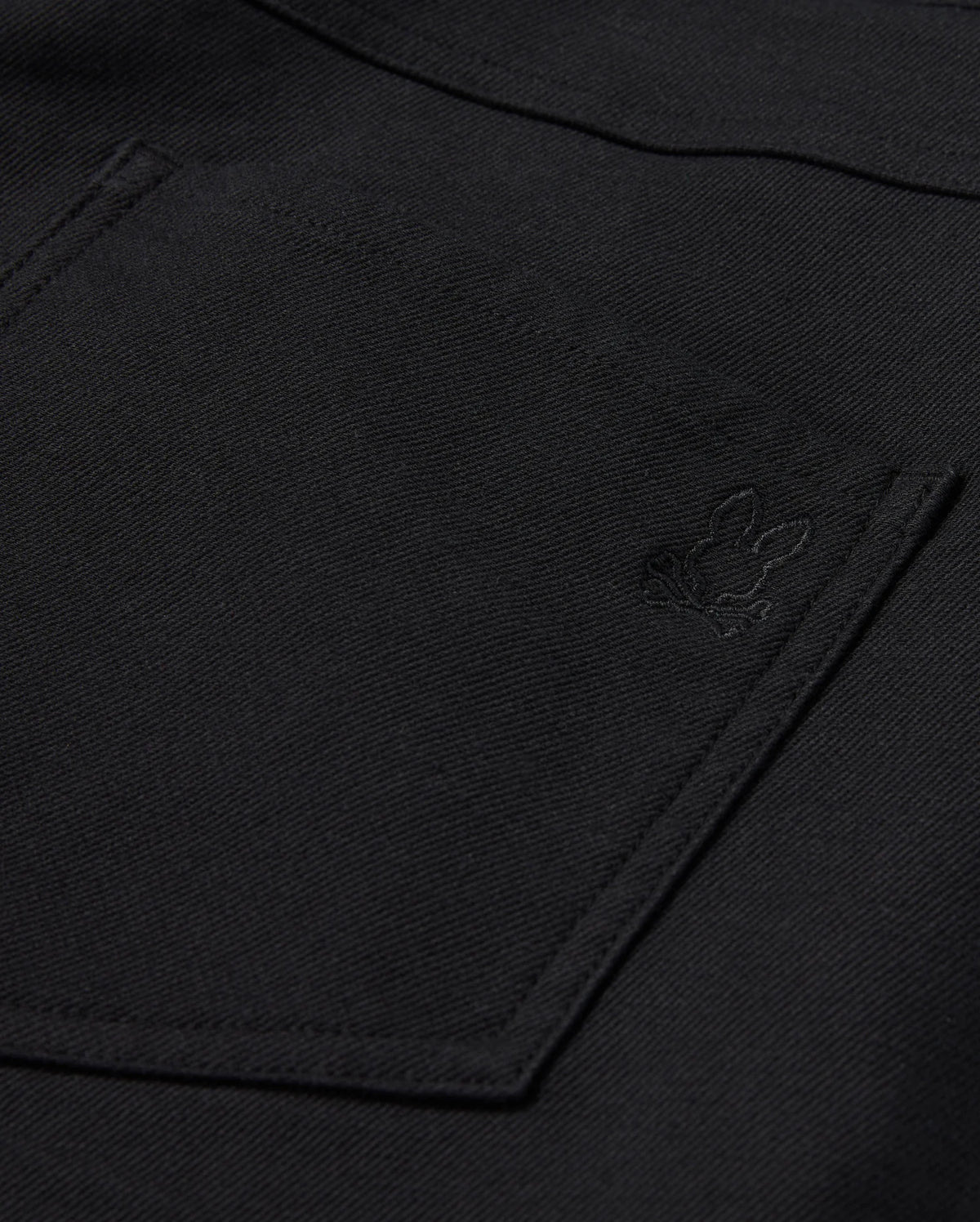 Close-up of the Psycho Bunny MENS HAYS TWILL PANT in black, made from a cotton-blend twill. It features a pocket adorned with an embroidered rabbit logo in the corner. The fabric has a textured appearance and provides ultimate comfort with its 4-way stretch design.