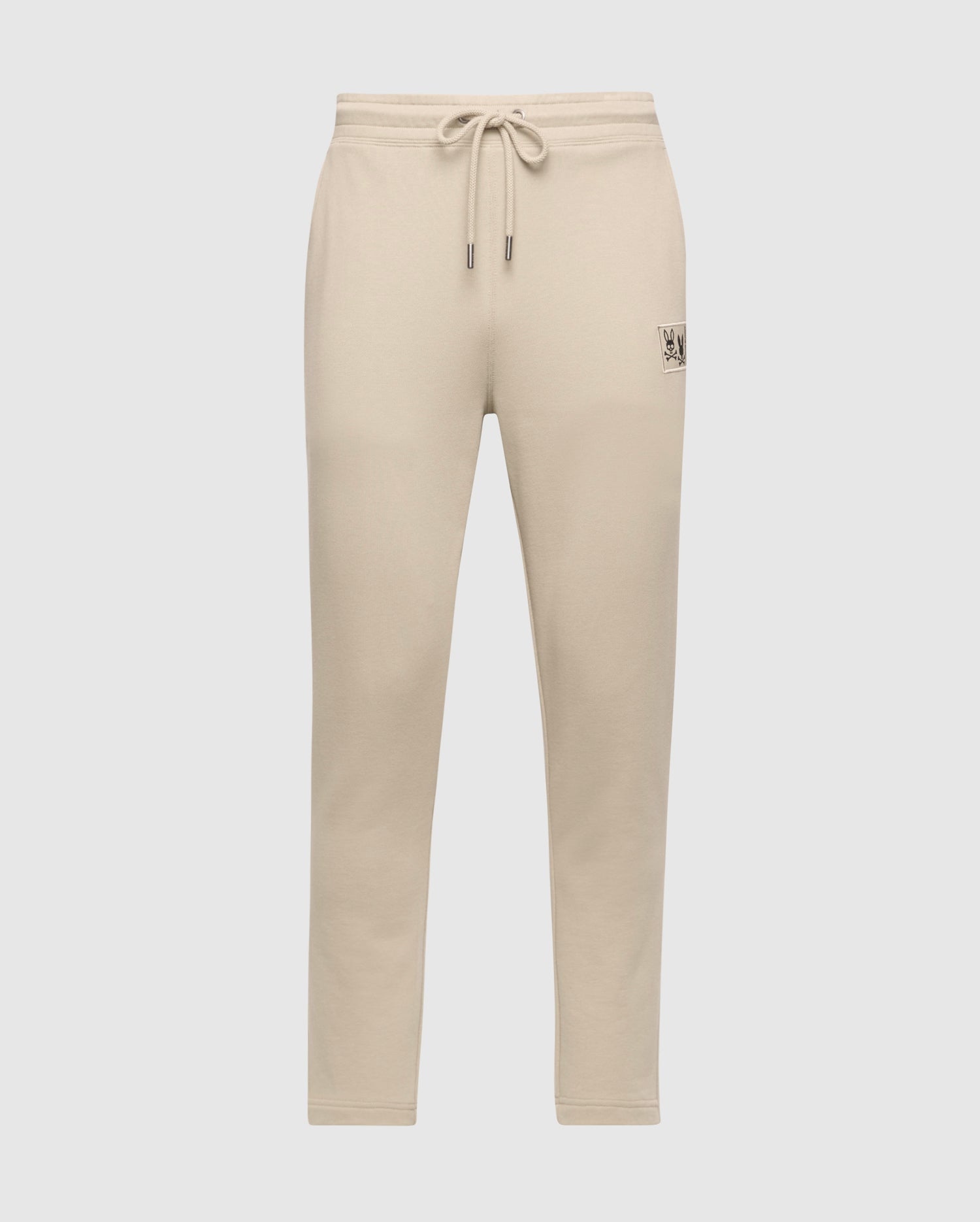 The Psycho Bunny MENS MONROE TWILL PATCH FLEECE SWEATPANT - B6P929D200, made from cozy French terry cotton, features a drawstring waistband and a small patch detail on the upper leg against a plain white background.
