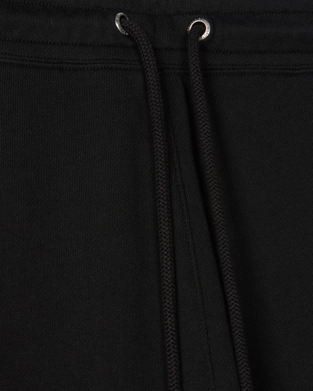 Close-up of black drawstrings on a black garment, likely the Psycho Bunny Men's Pacific Chenille Jogger (B6P972D200), featuring metal eyelets at the top. The fabric appears thick and textured, providing a casual bottom look ideal for everyday wear.
