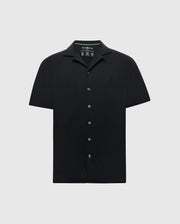 The Psycho Bunny MENS BRYAN CAMP COLLAR SHORT SLEEVE SHIRT (B6Q581F200) is a black Pima cotton blend button-up with a classic camp collar. It features an embroidered chest logo and offers style and moisture-wicking comfort in a simple design against a white background.