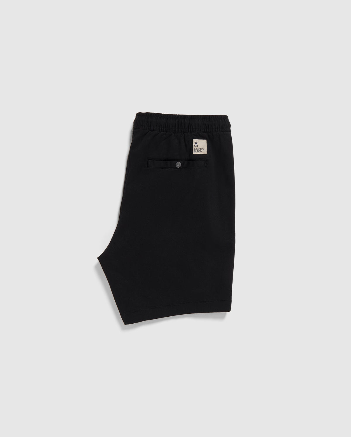 Black Psycho Bunny eco-friendly shorts with an elastic waistband and a label on the back, displayed on a plain white background.