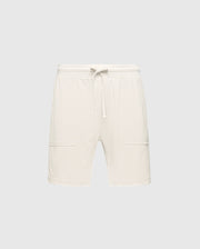 The MENS TAYLOR LIGHT PIQUE SWEATSHORT - B6R344F200 by Psycho Bunny are white athletic shorts made from lightweight Pima cotton, featuring an elastic waistband with a drawstring, two front pockets, and straight hems on a light gray background.