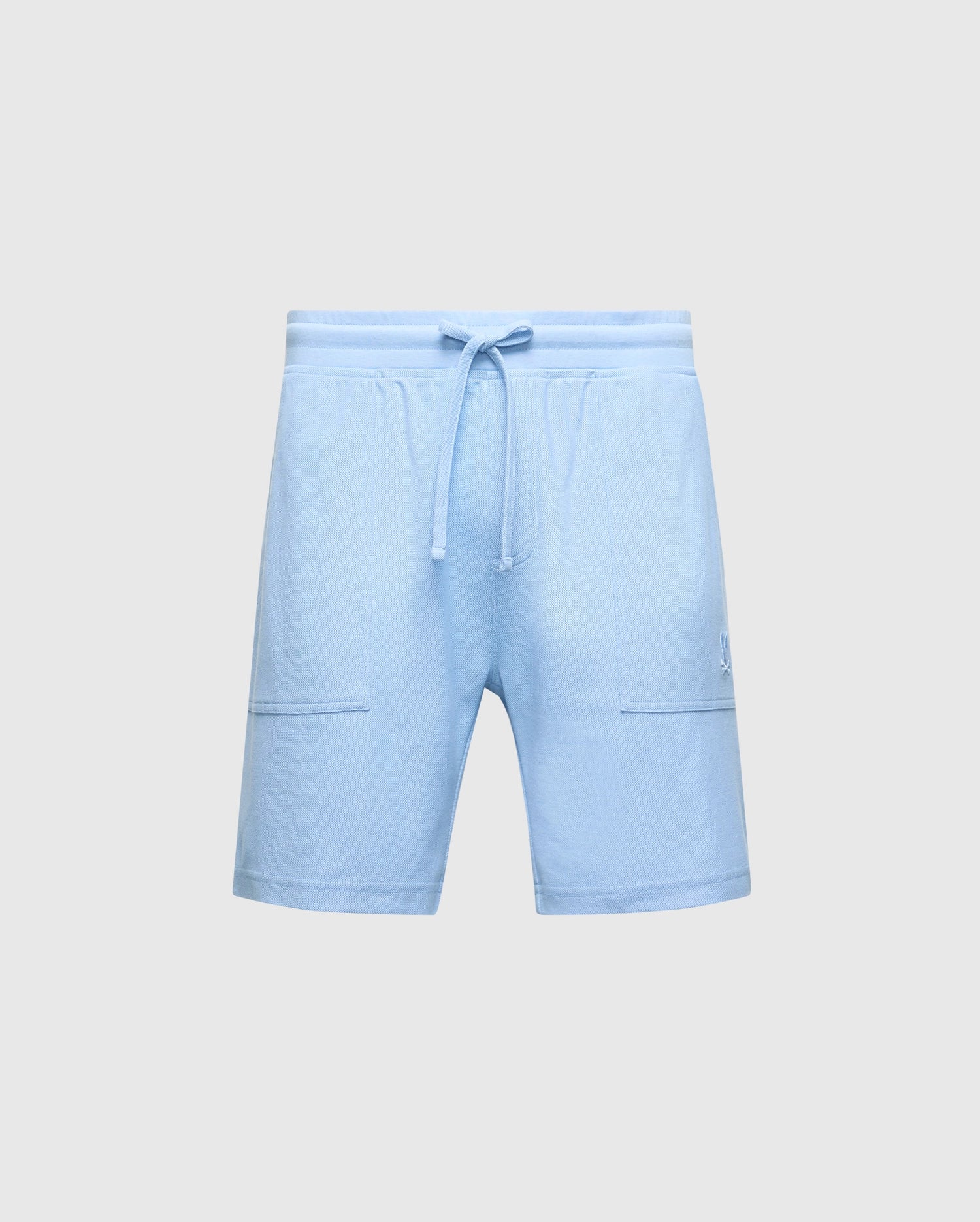 The Psycho Bunny MENS TAYLOR LIGHT PIQUE SWEATSHORT (B6R344F200) in light blue, featuring a drawstring waist and two front pockets, is showcased on a plain gray background, making it an essential casual-chic wardrobe addition.