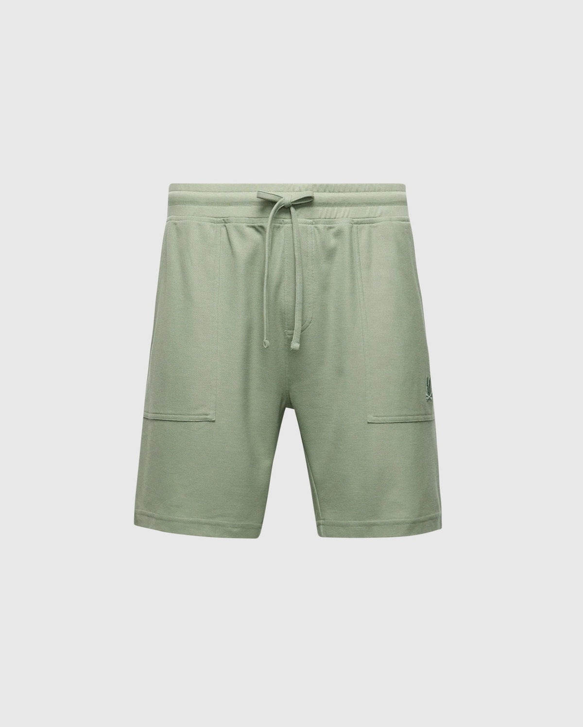 The MENS TAYLOR LIGHT PIQUE SWEATSHORT - B6R344F200 by Psycho Bunny are light green athletic shorts made from lightweight Pima cotton, featuring an elastic waistband with drawstring, two front pockets, and a subtle logo on the left side.