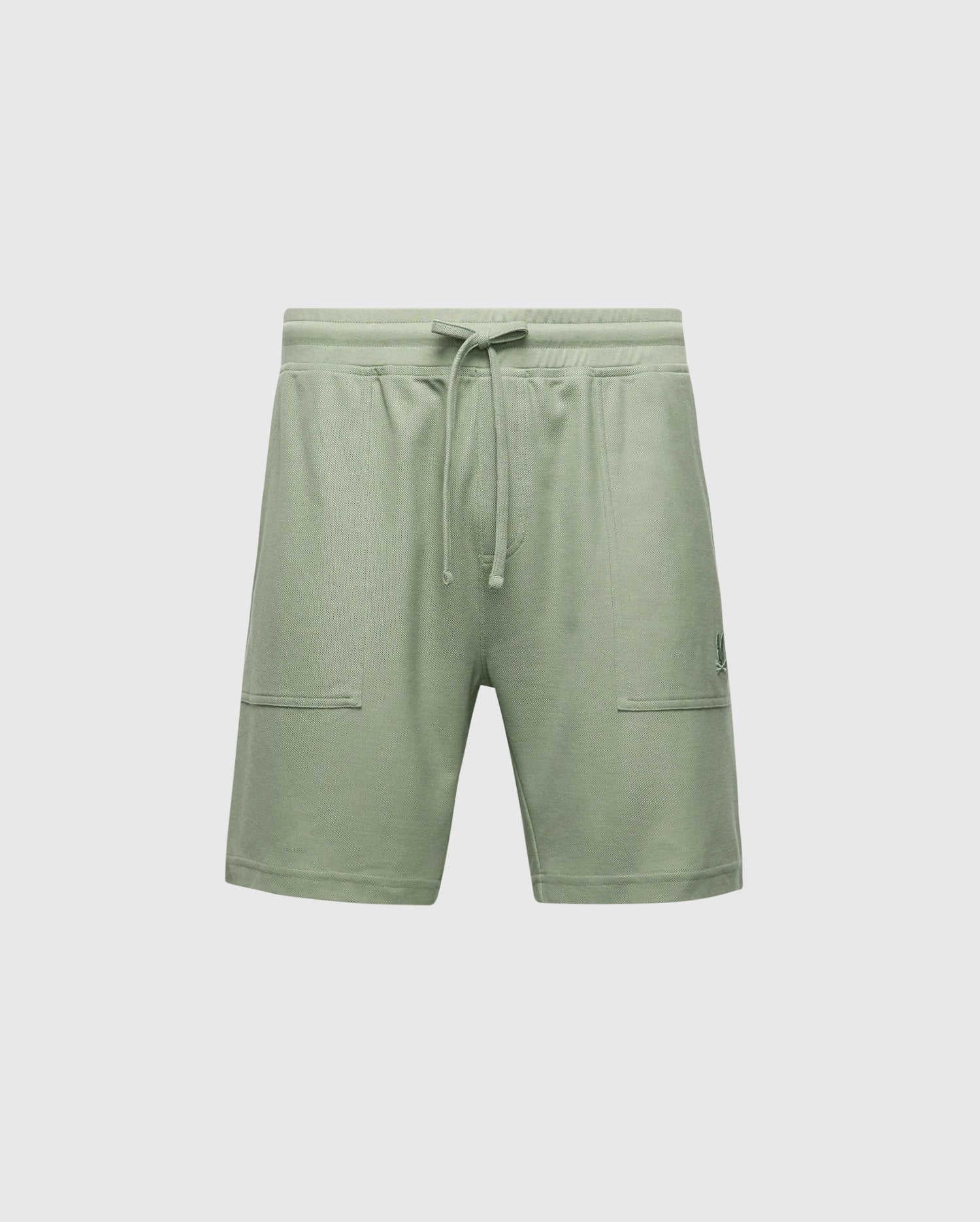 The MENS TAYLOR LIGHT PIQUE SWEATSHORT - B6R344F200 by Psycho Bunny are light green athletic shorts made from lightweight Pima cotton, featuring an elastic waistband with drawstring, two front pockets, and a subtle logo on the left side.