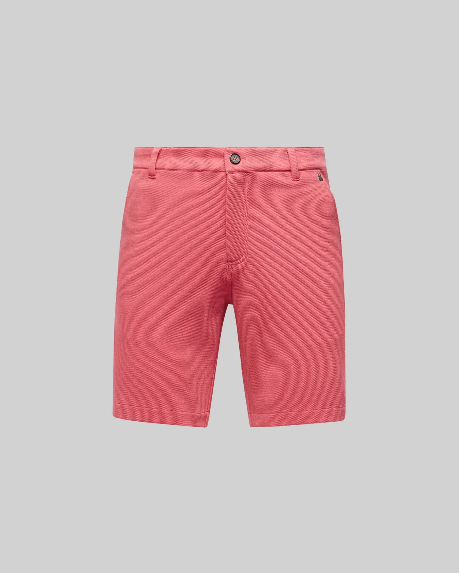 The Psycho Bunny MENS SHIRO KNIT HONEYCOMB SHORT - B6R585F200 features belt loops, a button closure, and side pockets in pink honeycomb-patterned piqué, shown on a plain light grey background.